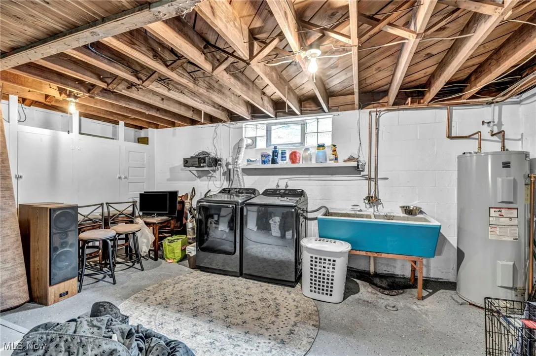 Basement with washing machine and clothes dryer and water heater