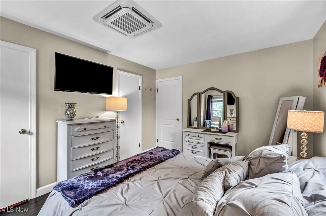 Bedroom featuring wood finished floors and cooling unit