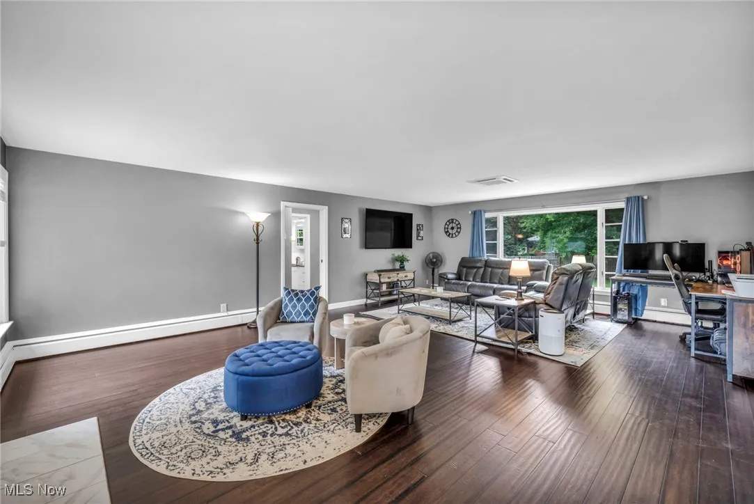 Living area with a baseboard radiator and wood finished floors