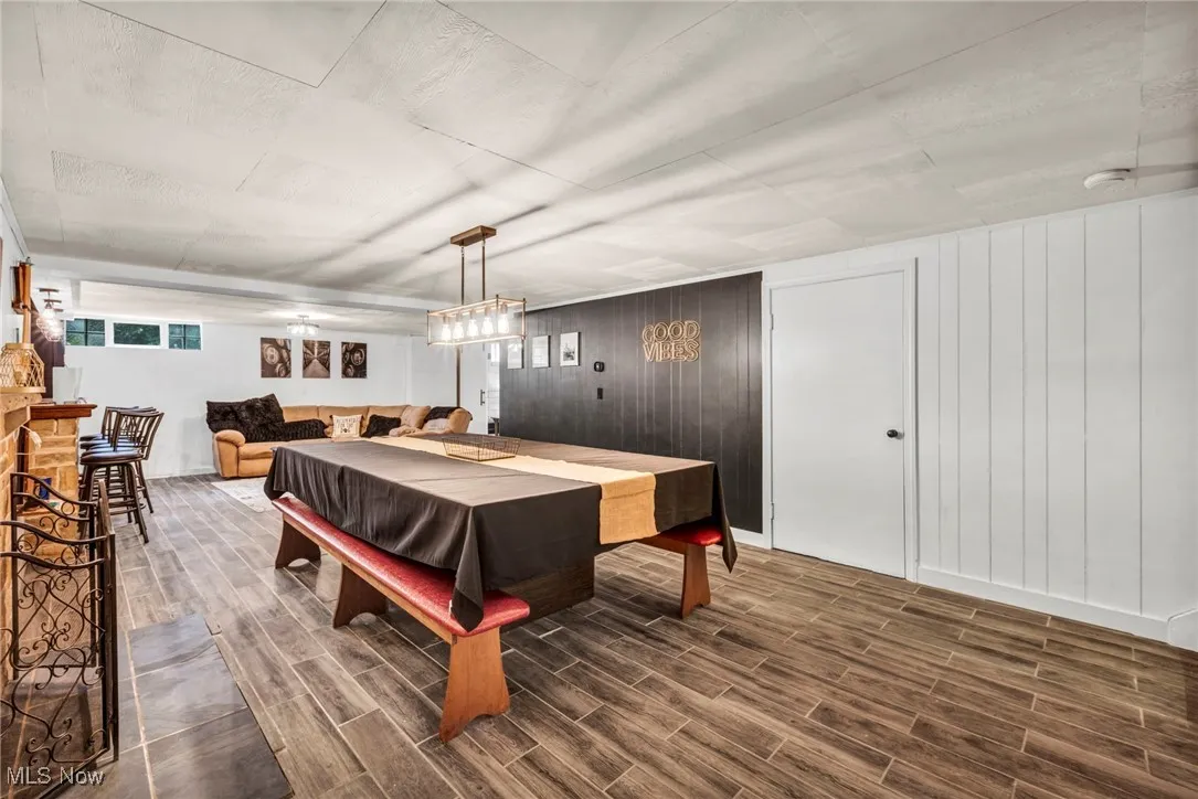 Recreation room featuring dark wood finished floors, pool table, and wooden walls