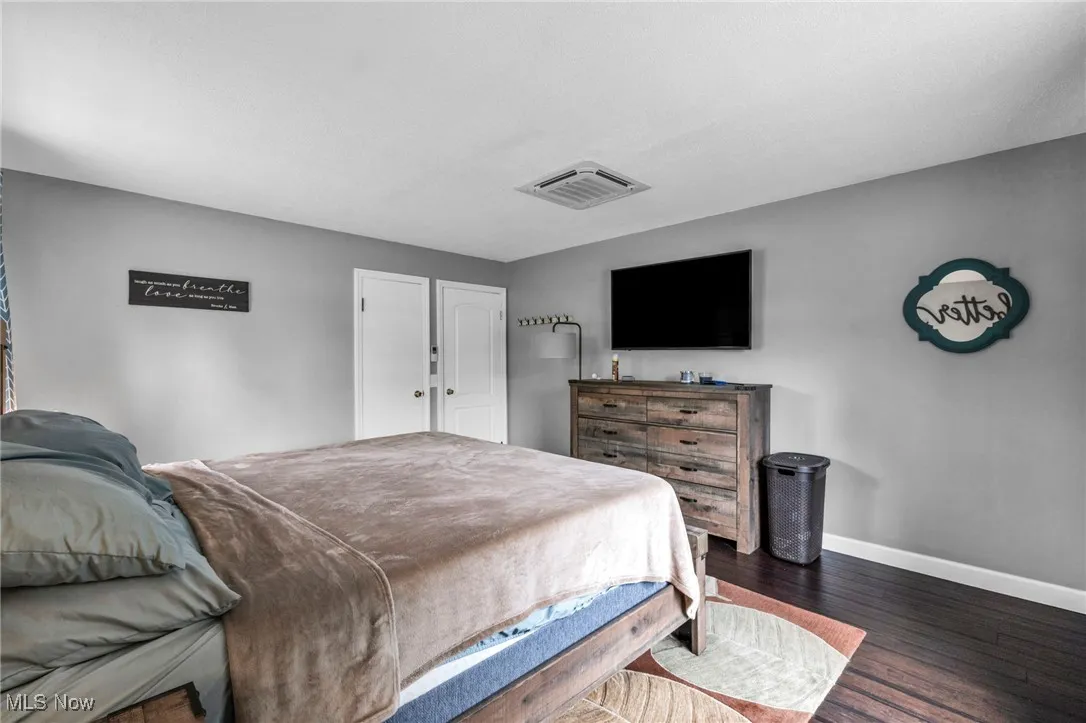 Bedroom featuring baseboards and dark wood finished floors