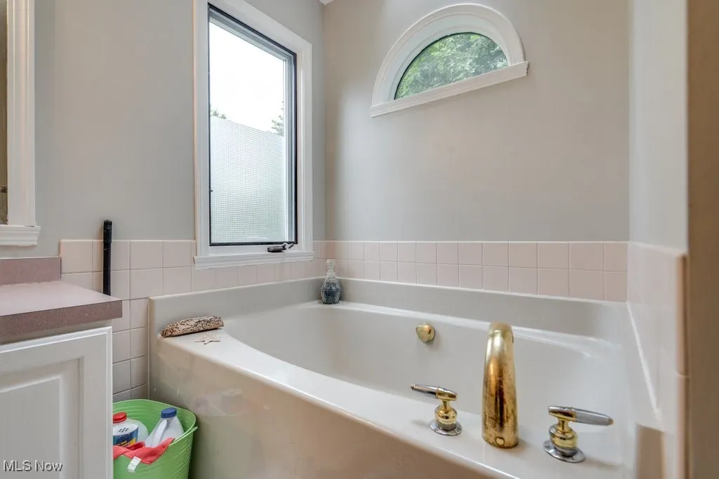 Full bath with a bath and vanity