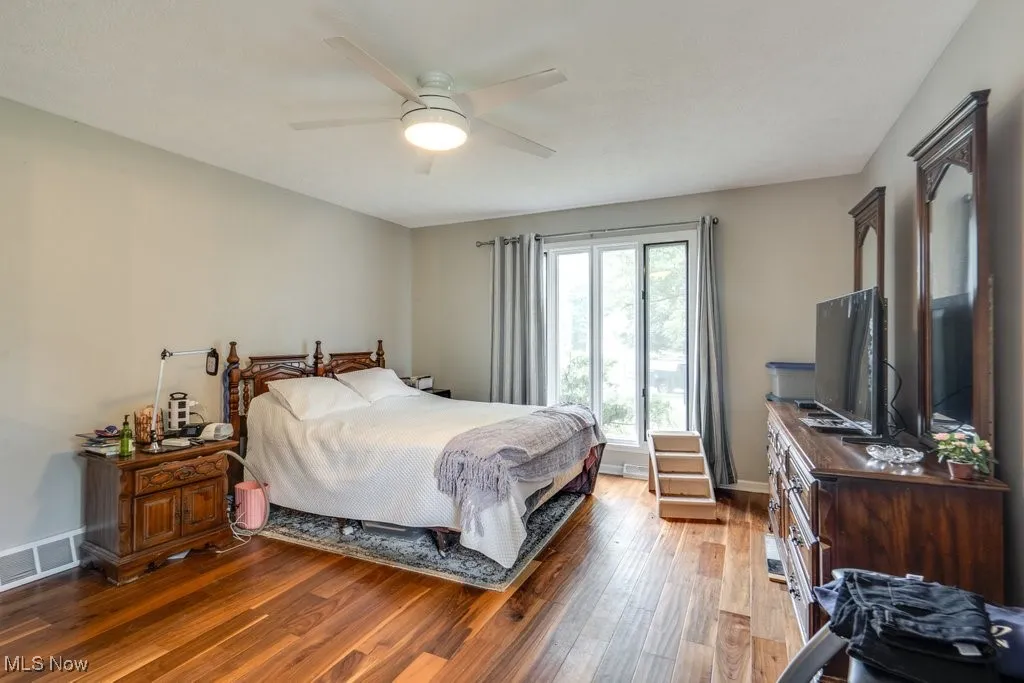 Bedroom featuring wood-type flooring and a ceiling fan