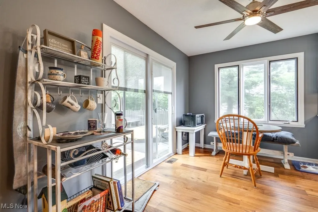 Dining space with ceiling fan and wood finished floors