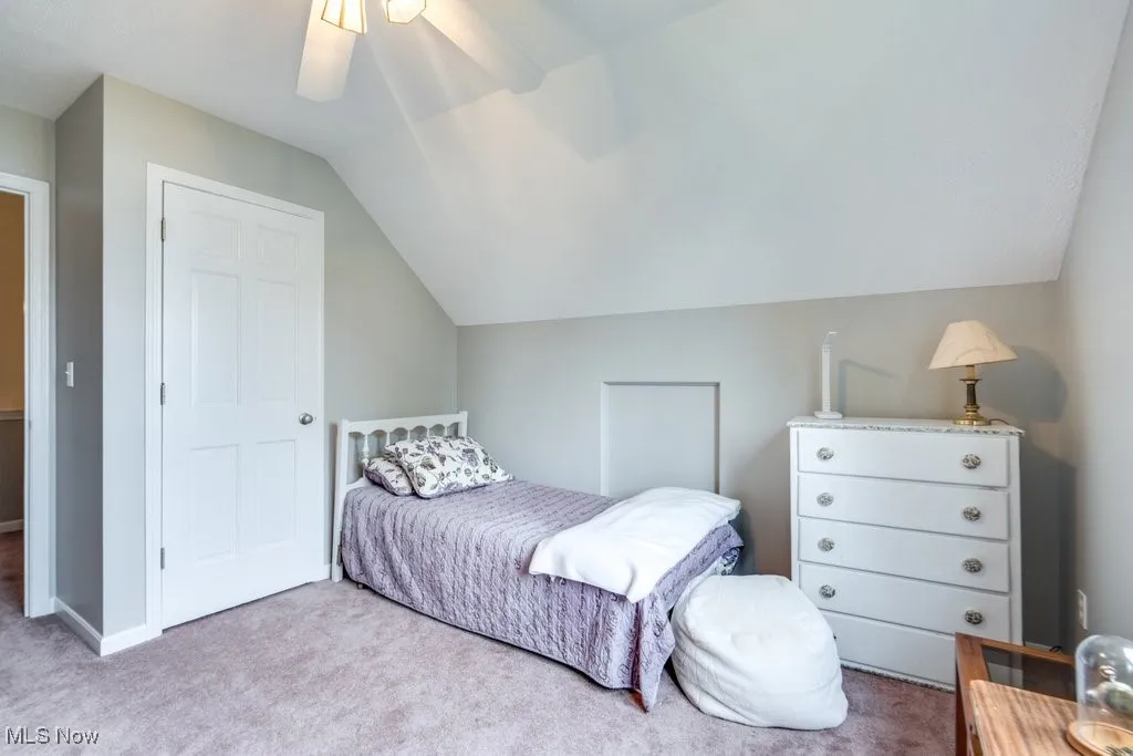 Bedroom featuring carpet floors, lofted ceiling, and ceiling fan