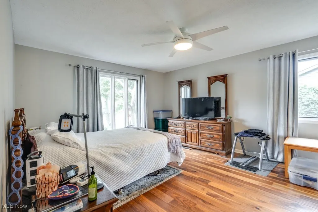 Bedroom with light wood-style floors and ceiling fan