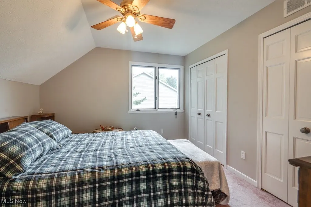 Bedroom with light carpet, lofted ceiling, and a ceiling​​‌​​​​‌​​‌‌​‌‌​​​‌‌​‌​‌​‌​​​‌​​ fan
