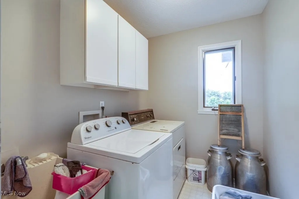 Laundry room featuring washer and dryer and cabinet space