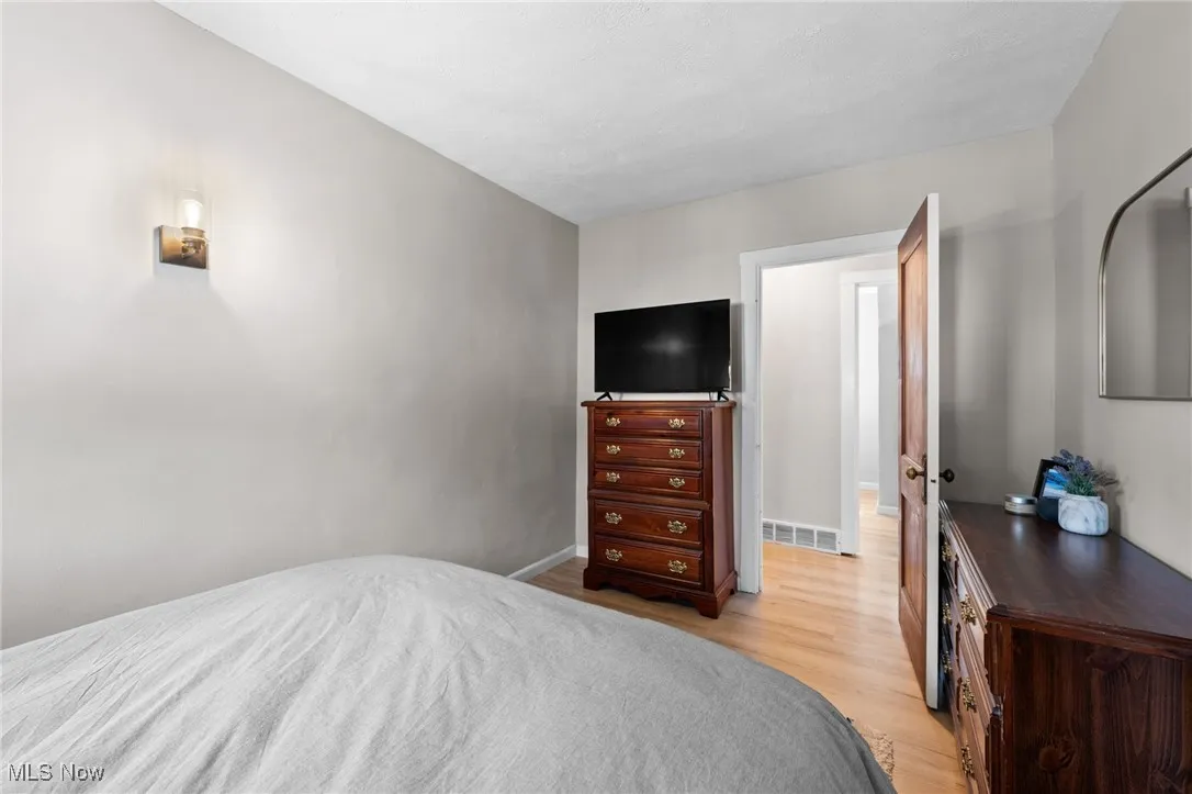 Bedroom featuring light wood-style flooring and baseboards