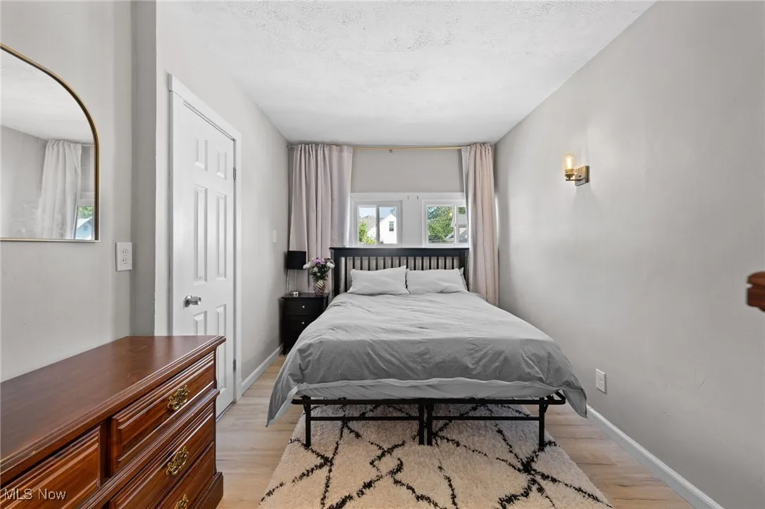 Bedroom featuring light wood-style floors and a textured ceiling