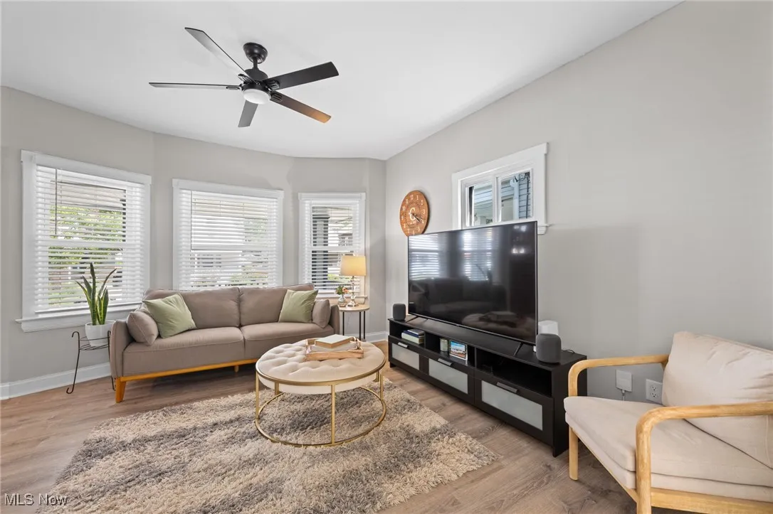 Living room featuring wood style floors and a ceiling fan
