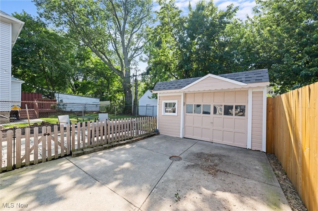 Detached garage featuring concrete driveway