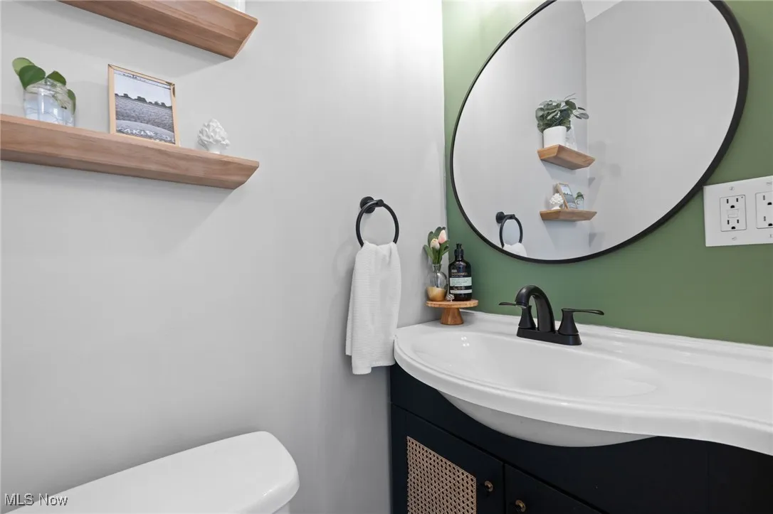 Half bath featuring vanity and toilet