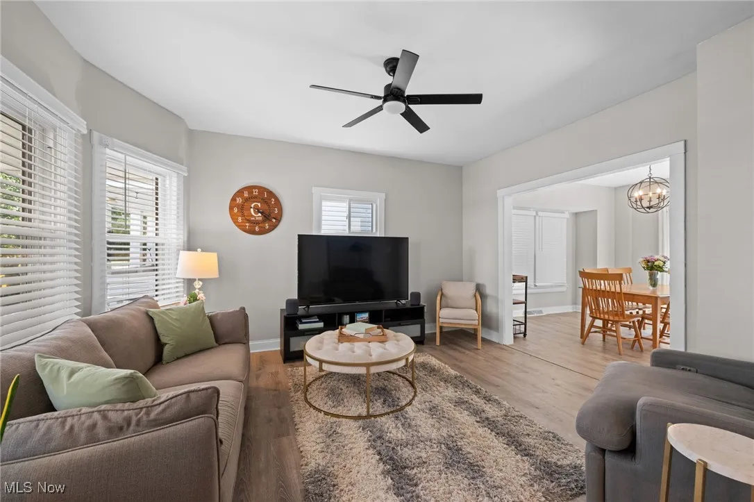 Living area with plenty of natural light, a ceiling fan, wood style floors