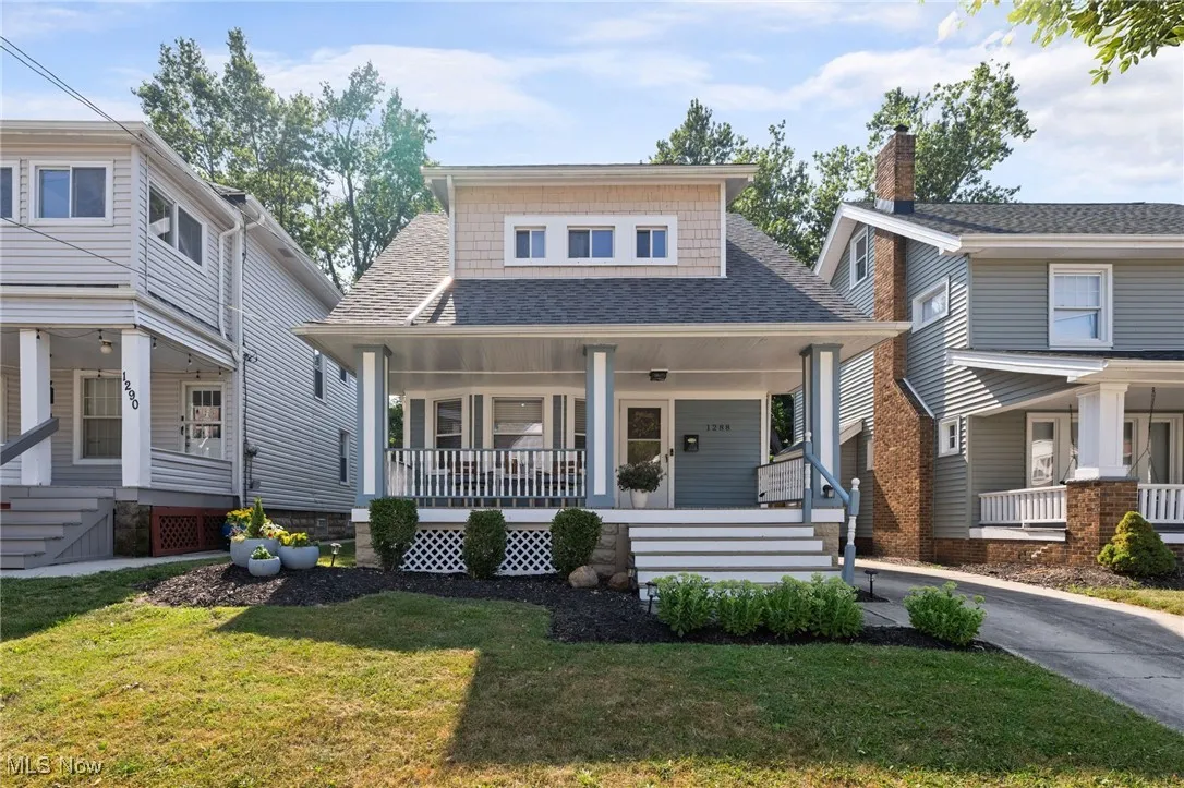 View of front of house with a porch, and a front lawn