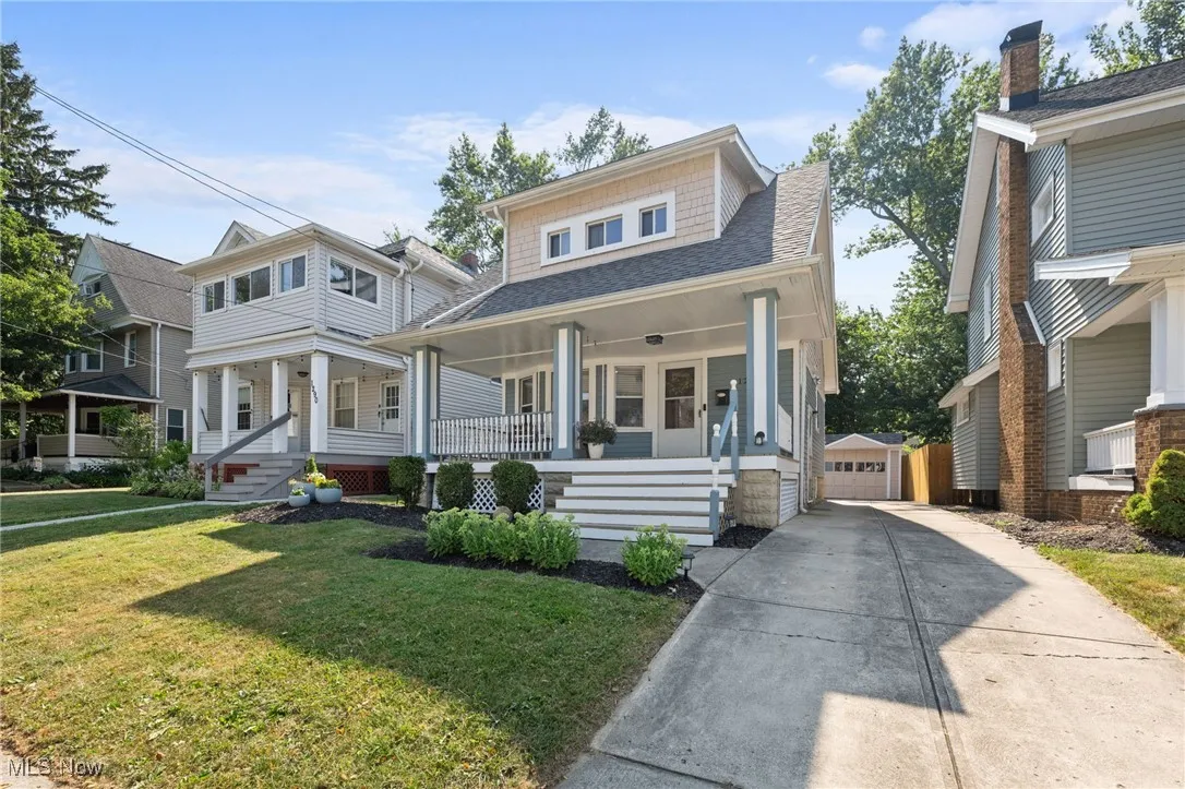 View of front of property with a porch, and a front lawn