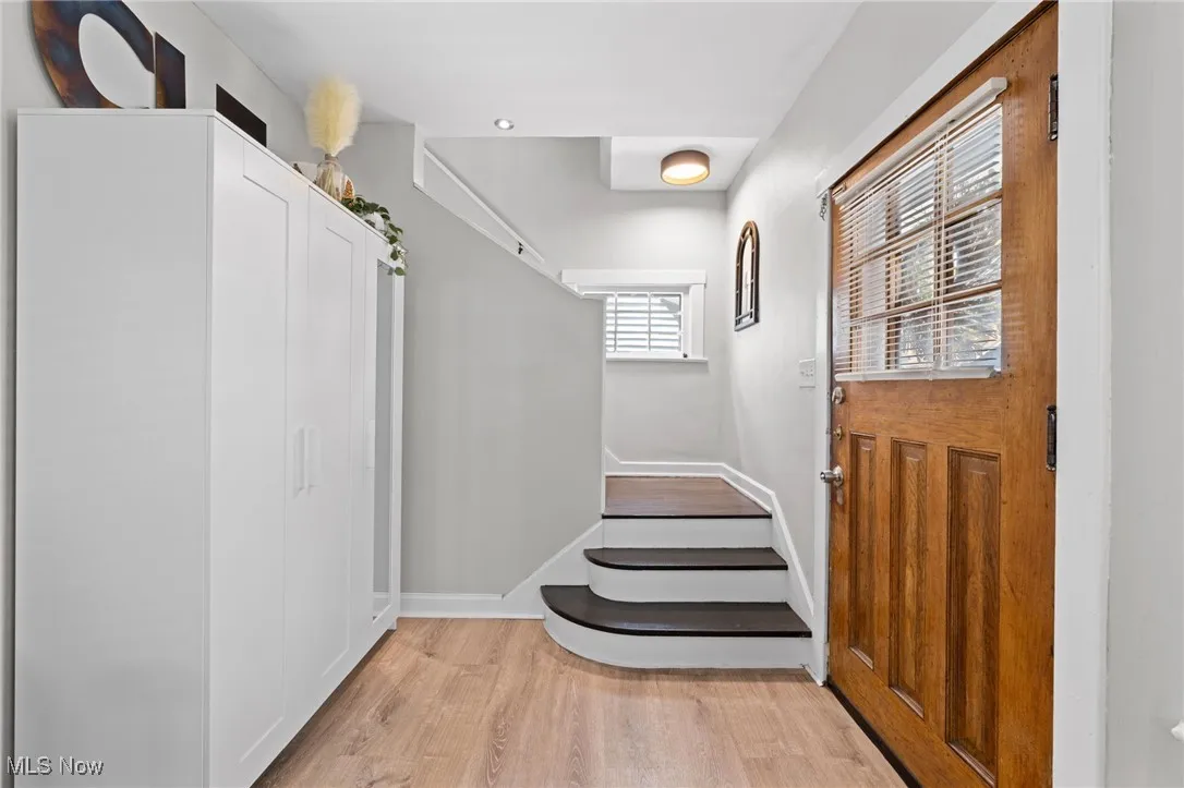 Doorway featuring light wood-style flooring and stairs