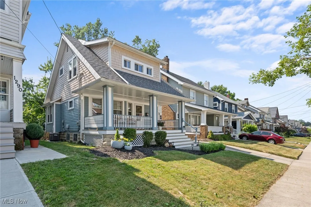 View of front of house featuring covered porch, and a front yard