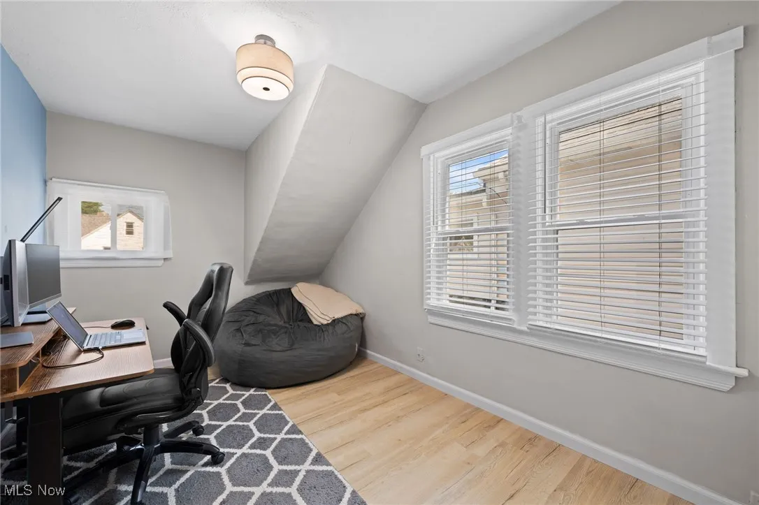 Bedroom featuring wood style floors and healthy amount of natural light