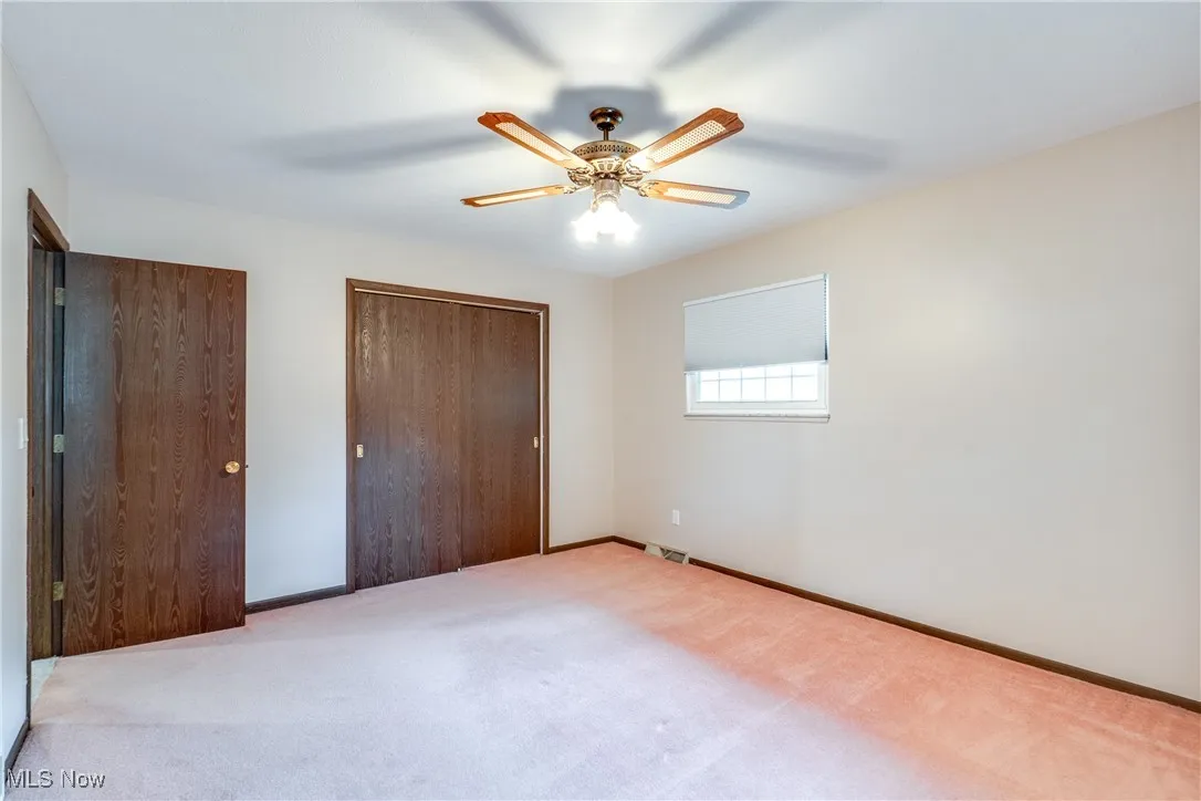 Unfurnished bedroom with carpet flooring, a closet, and ceiling fan