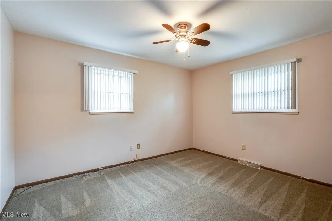 Spare room with carpet and ceiling fan