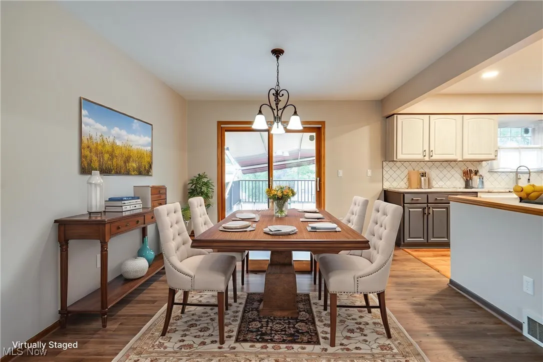 Dining room featuring a chandelier and light wood-type flooring