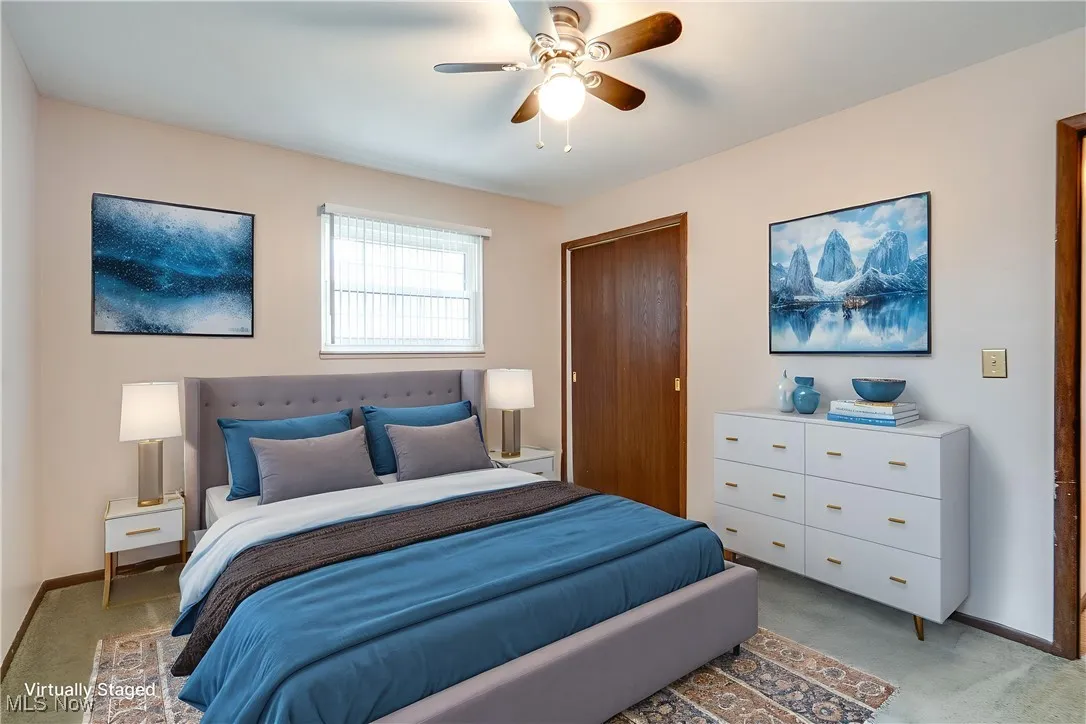 Bedroom with light carpet and a ceiling fan