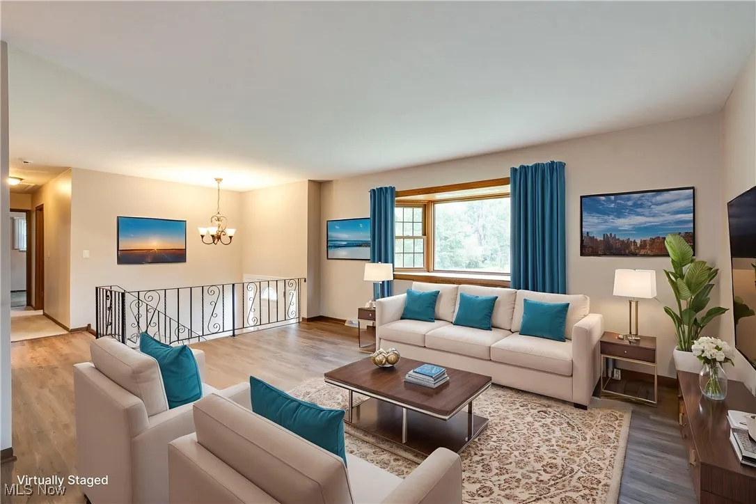 Living room featuring a chandelier and wood finished floors