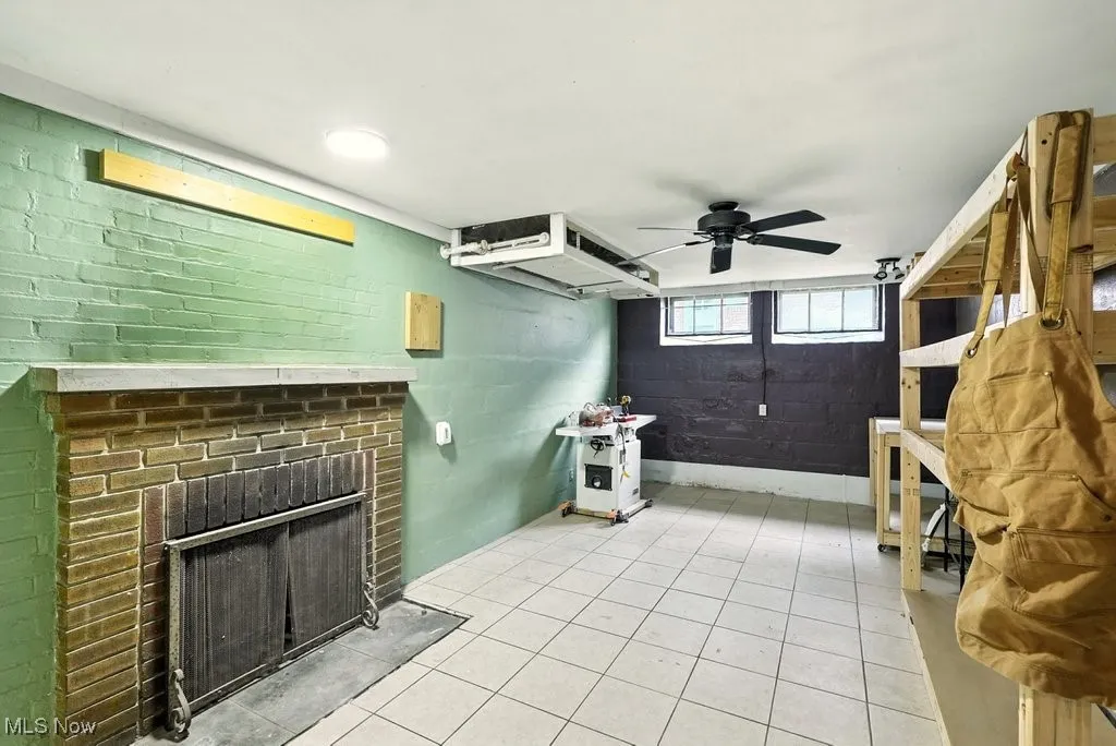 Basement area with fireplace and ceramic flooring