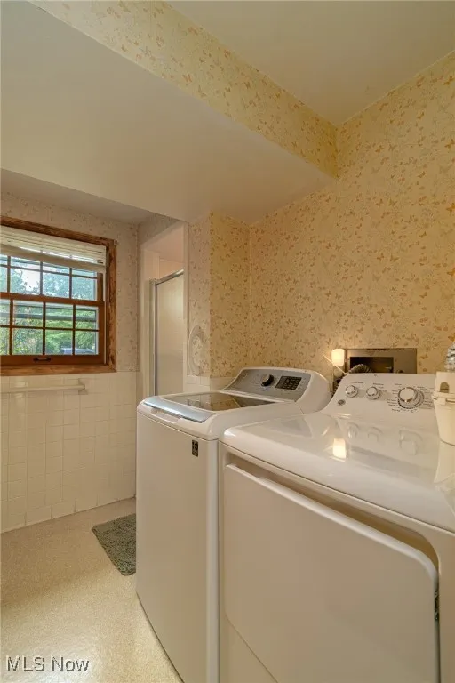 Lower full bath offers a walk-in shower and is combined laundry room. Washer and dryer remain.