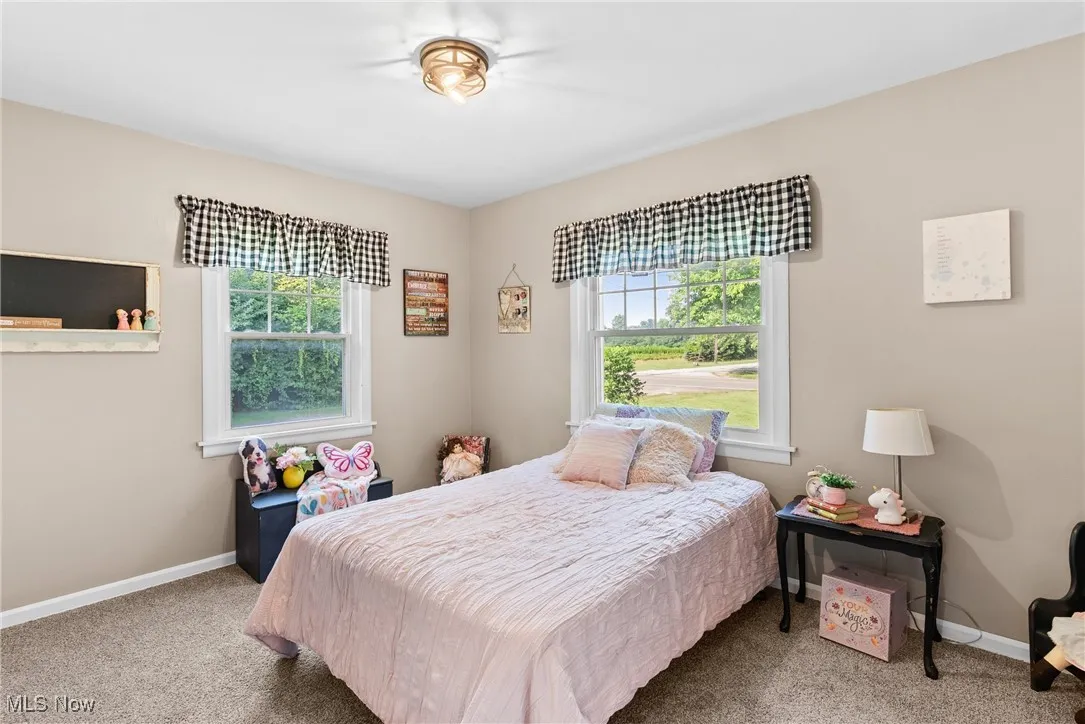 Carpeted bedroom featuring baseboards