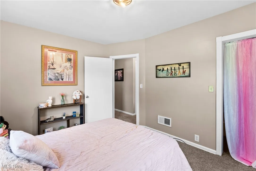 Carpeted bedroom featuring baseboards