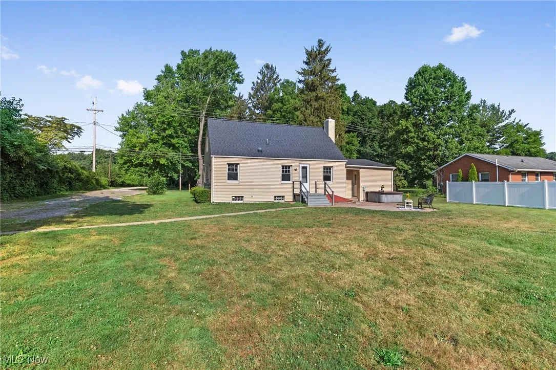 Back of house featuring a chimney