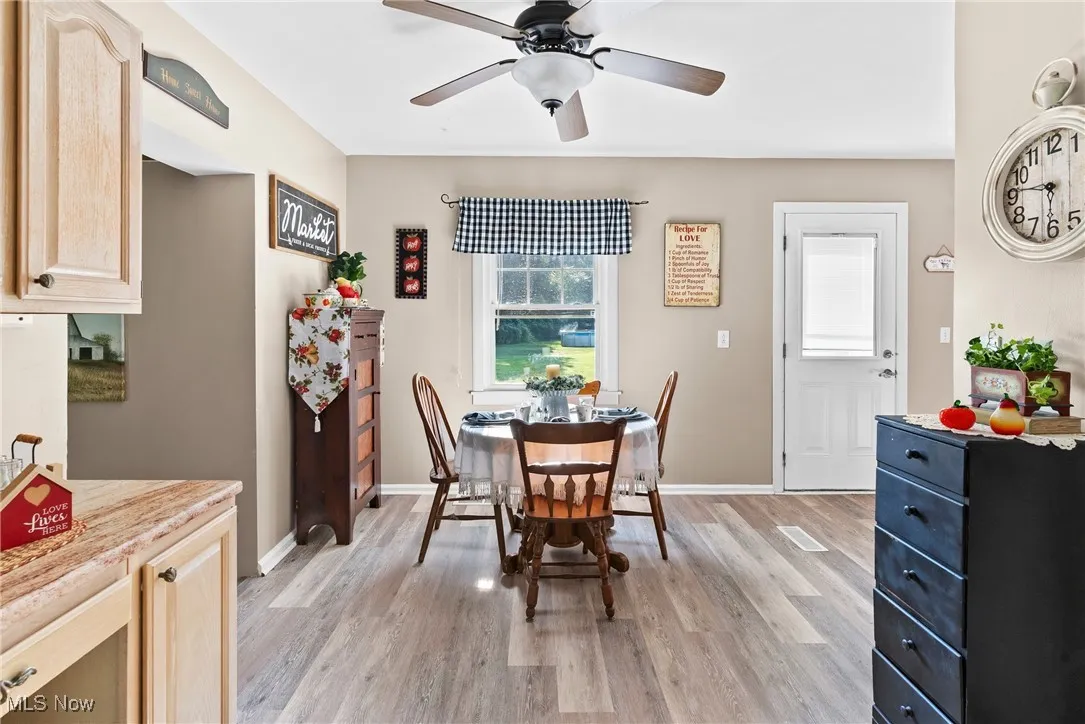 Dining area featuring light wood-style floors and ceiling fan