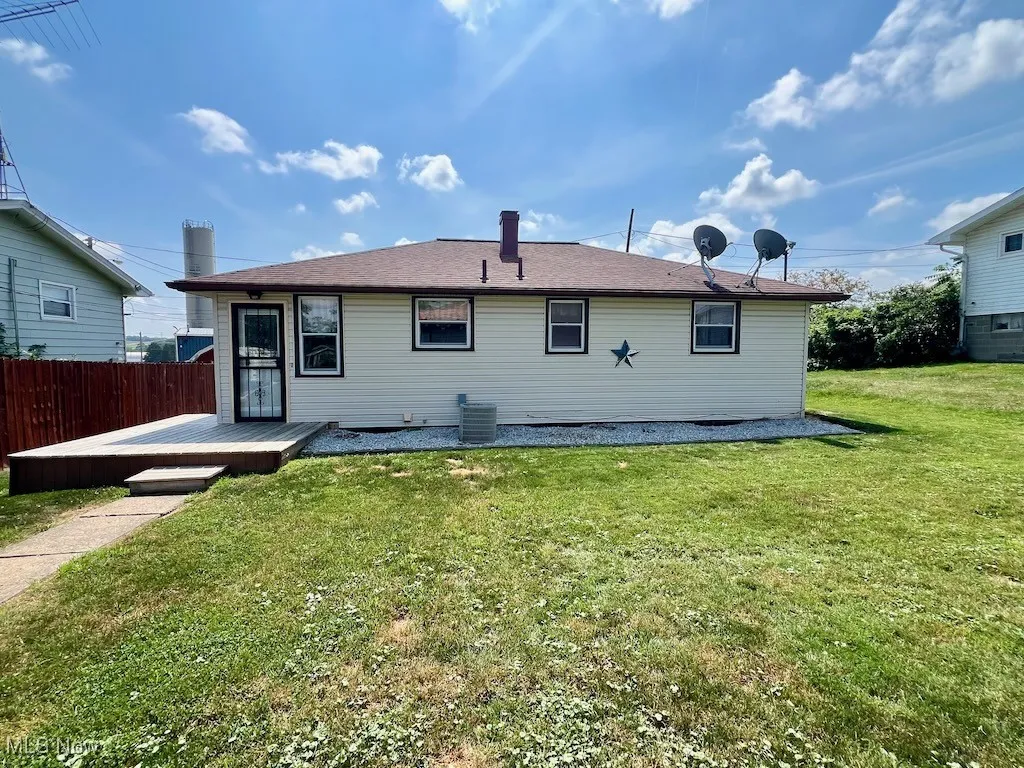 Back of property with a deck