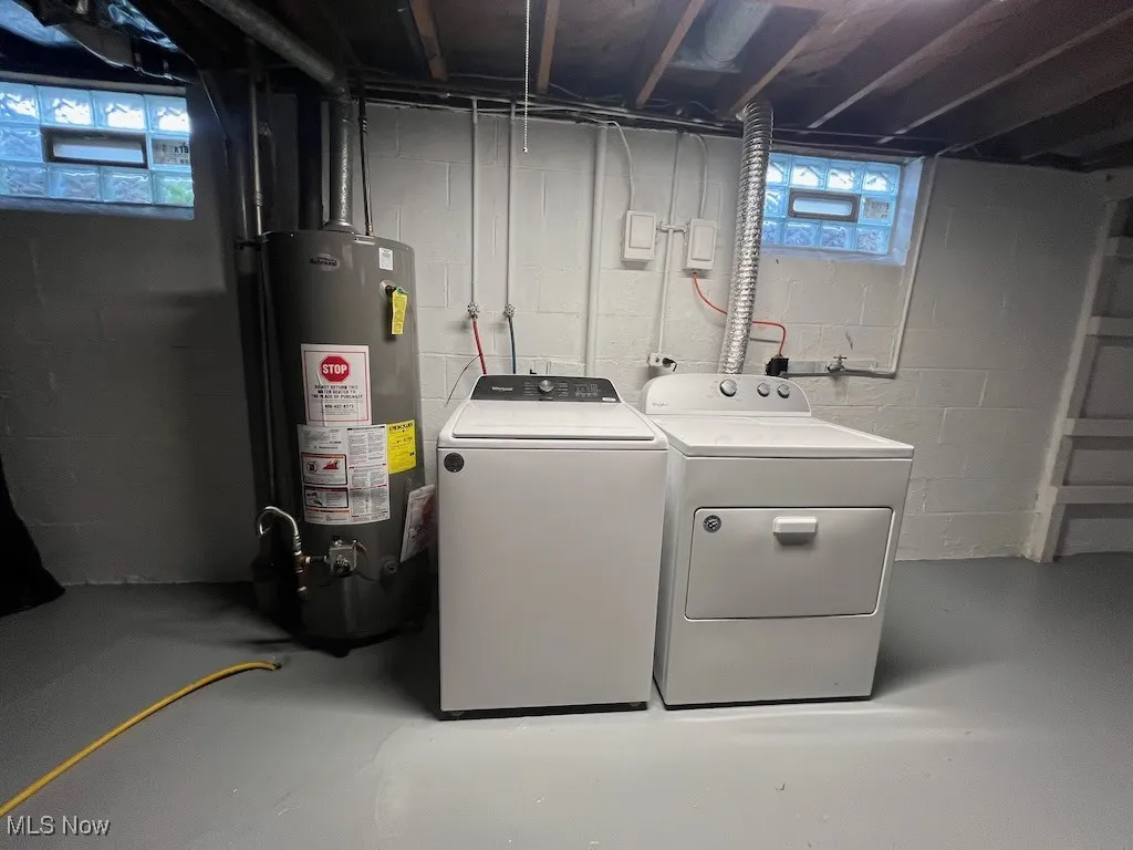 Laundry room with separate washer and dryer and gas water heater