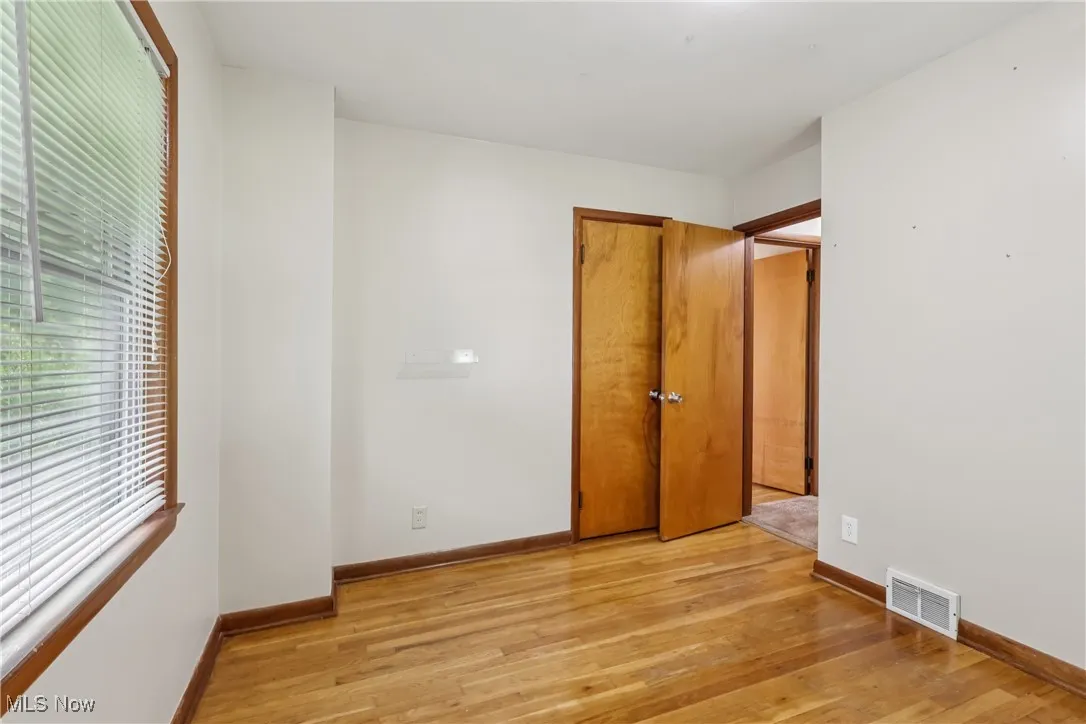 Unfurnished bedroom with light wood-type flooring and baseboards