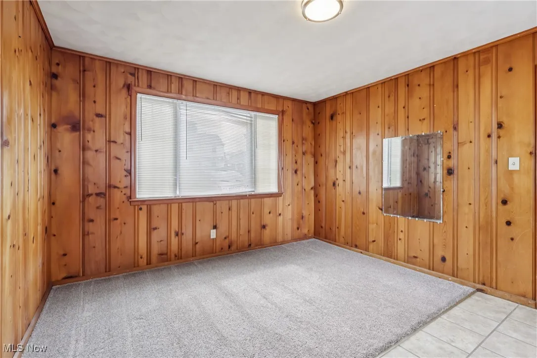 Unfurnished room with wooden walls