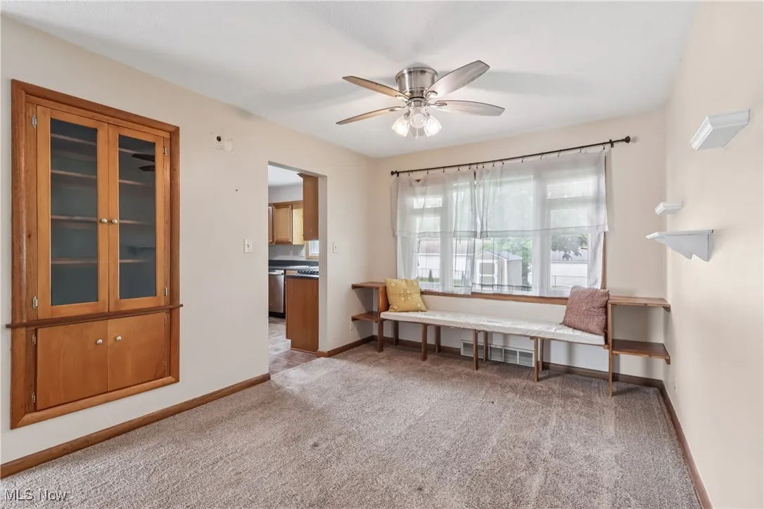 Sitting room with carpet and ceiling fan