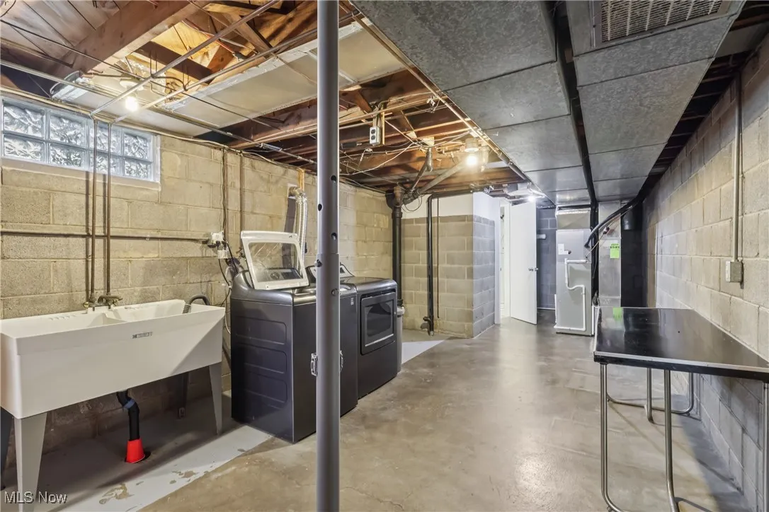 Below grade area with washer and dryer and heating unit
