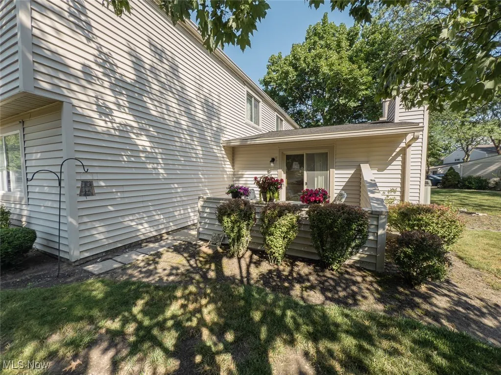 View of property exterior featuring landscaping around the patio