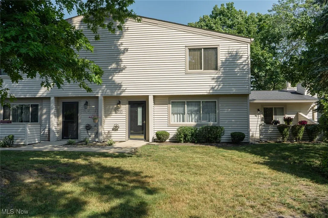 View of front of house with a front lawn and patio on the right