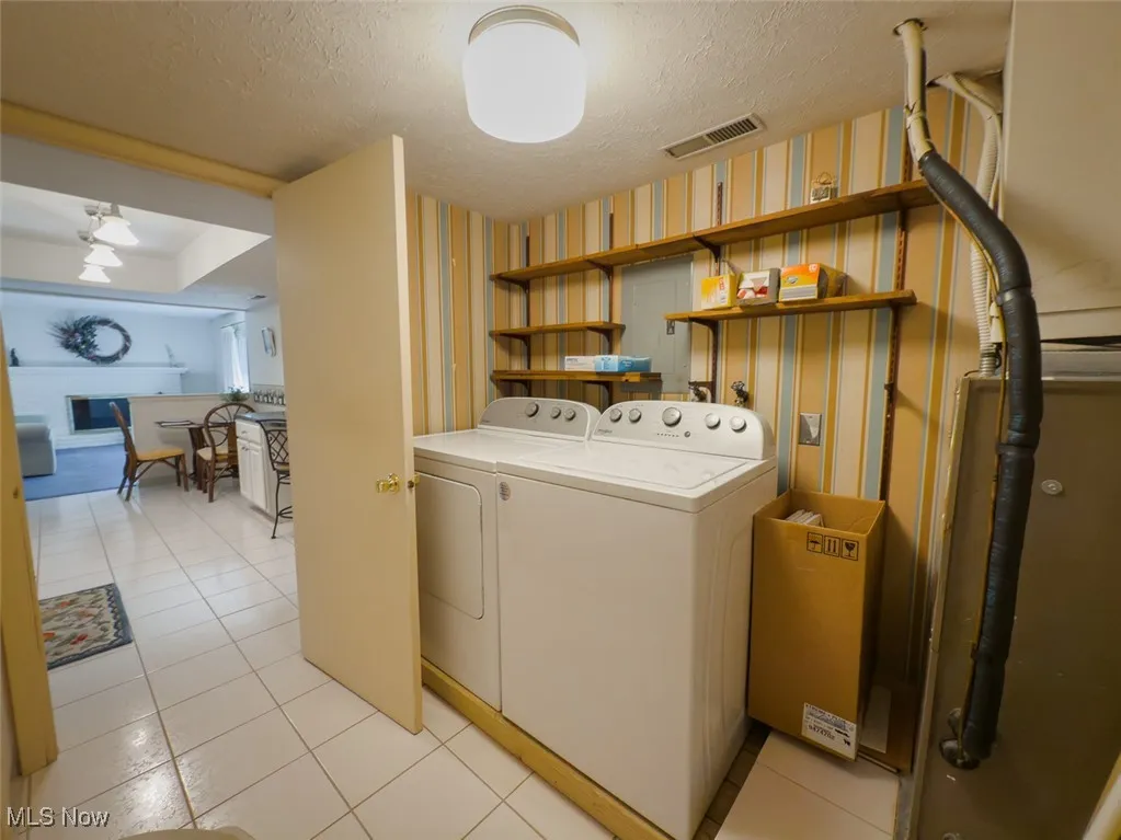Laundry and utility area with washer and dryer and tile floors