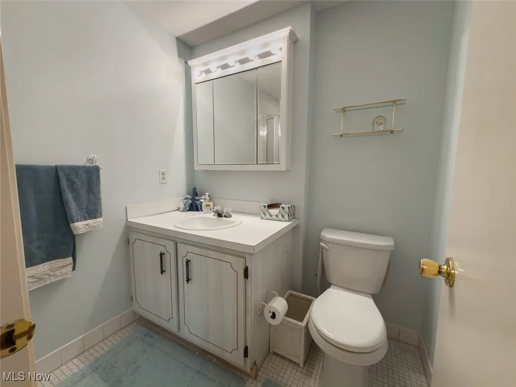 Full bath featuring vanity and tile patterned flooring