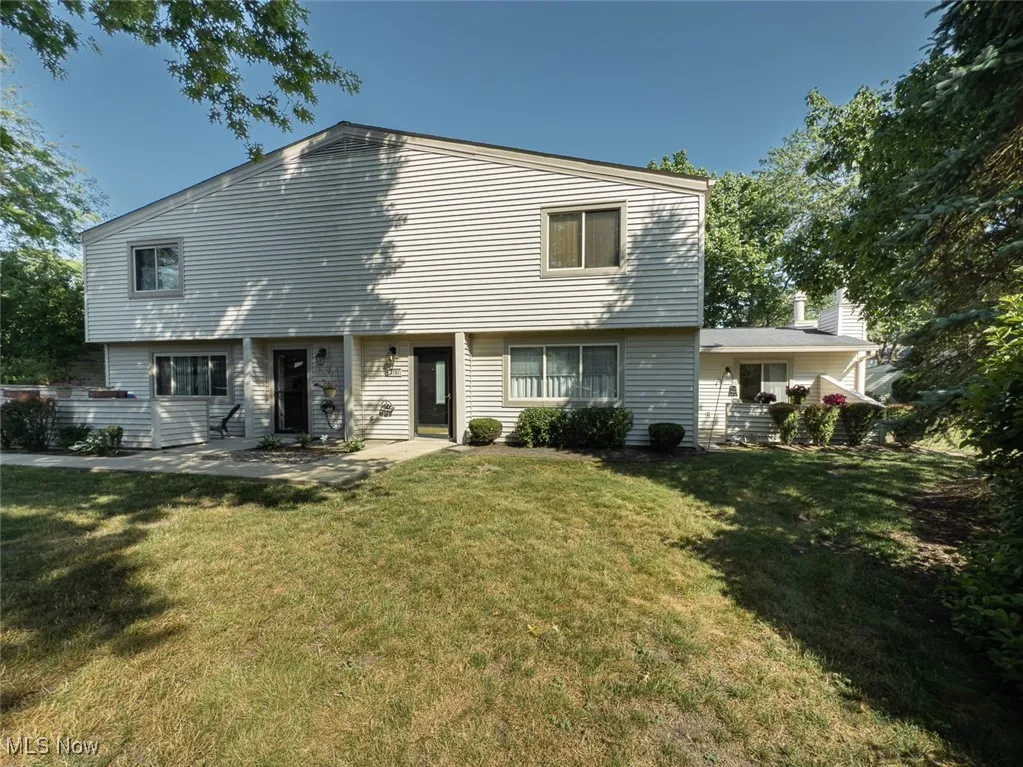 View of front of house with a front lawn and patio on the right