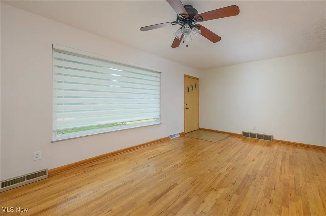 Spare room with light wood-style flooring and a ceiling fan