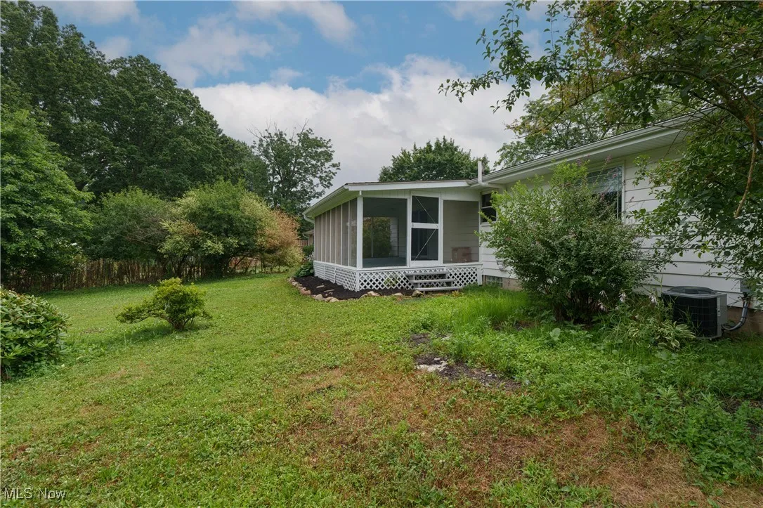 View of yard featuring a sunroom