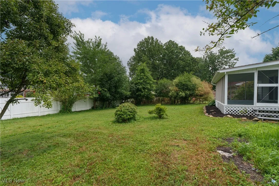 View of yard featuring a sunroom