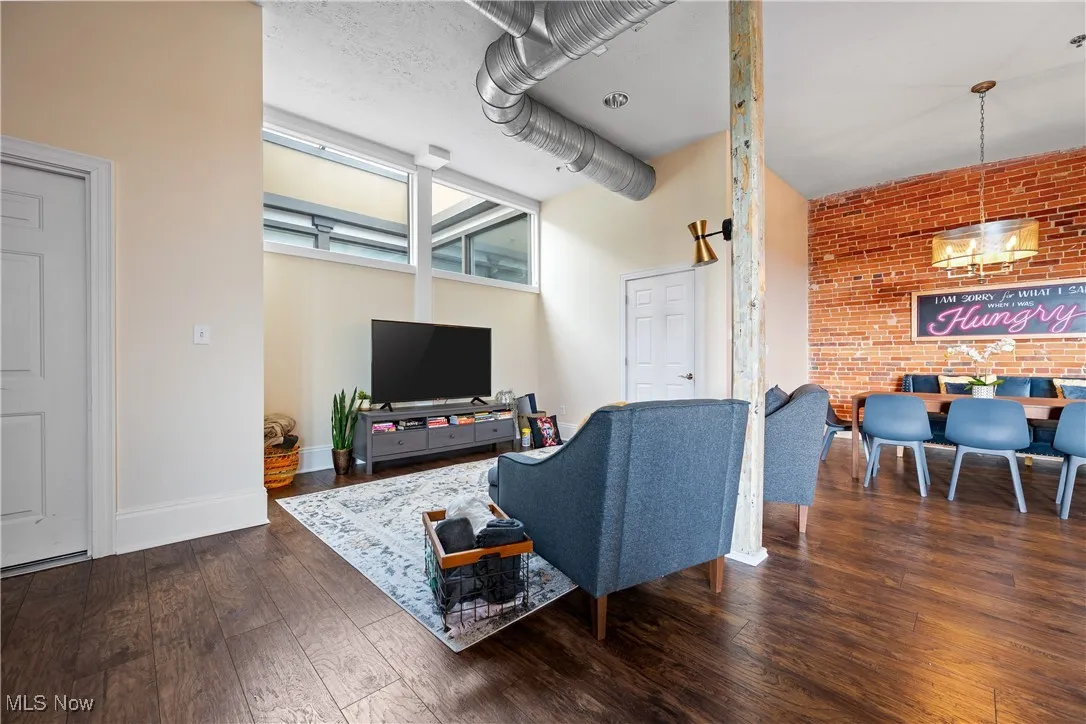 Living room featuring wood finished floors and brick wall