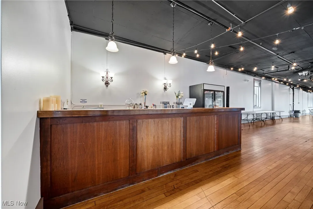 Bar area with hardwood / wood-style floors